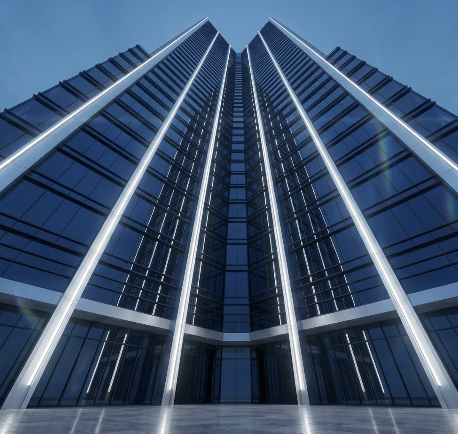 Low-angle view of a modern glass skyscraper with vertical white light strips at the entrance.