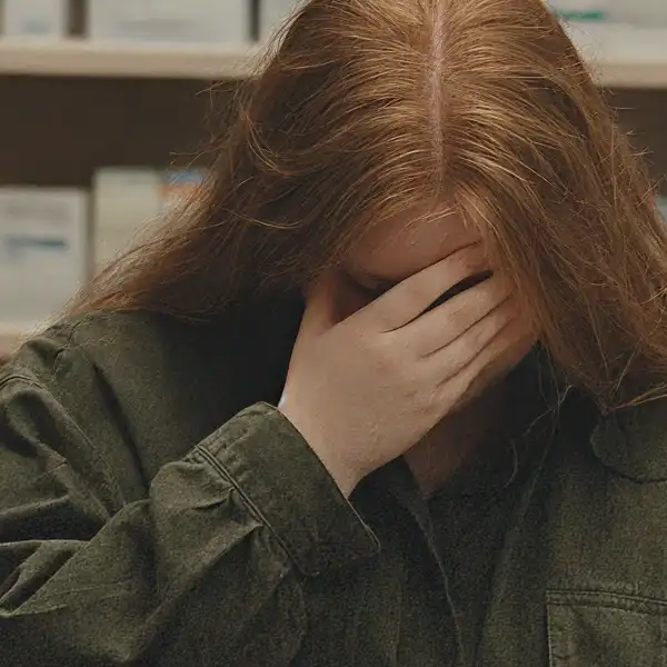 Stressed plus-sized woman feeling overwhelmed at the pharmacy while filling her GLP-1 prescription.