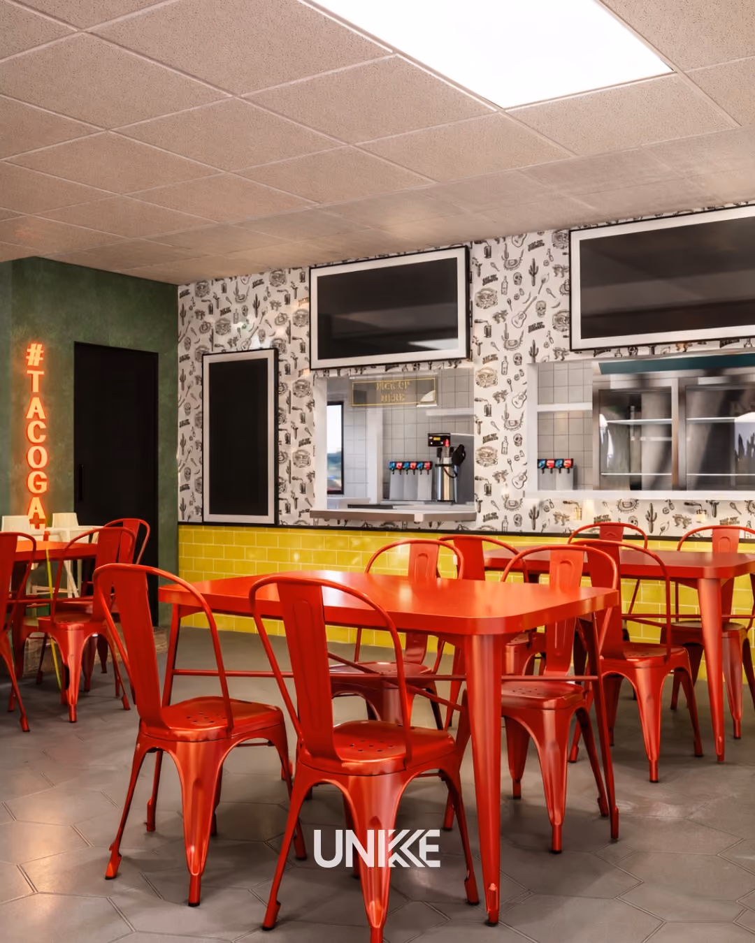 Interior of a restaurant with red metal chairs and tables, yellow tiled counter, and black menu boards.