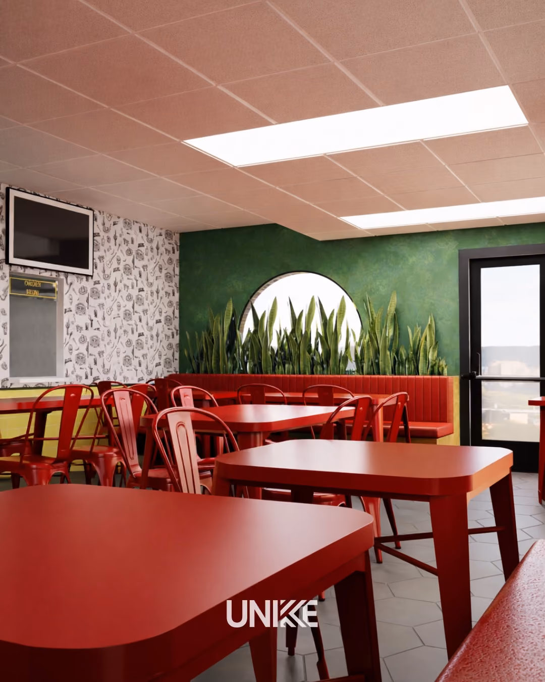 Interior of a dining area with red tables, red chairs, green wall with plants, and a round window.