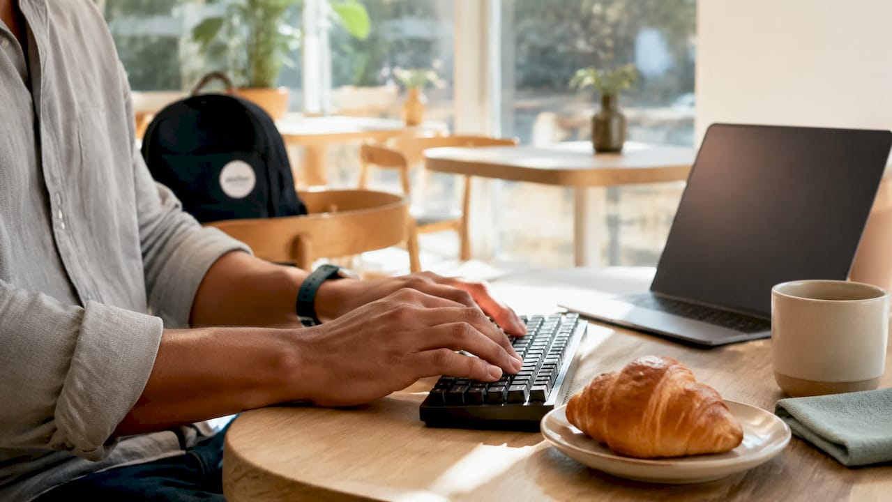 Hands typing and reviewing crawlability documents