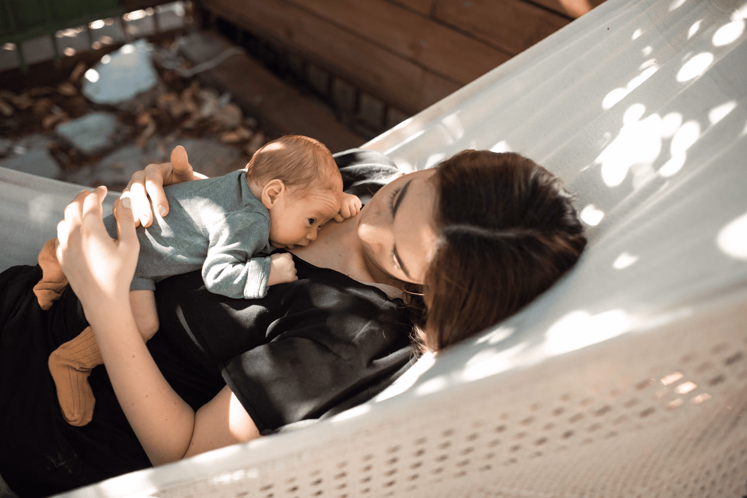Mother holding her newborn baby at home