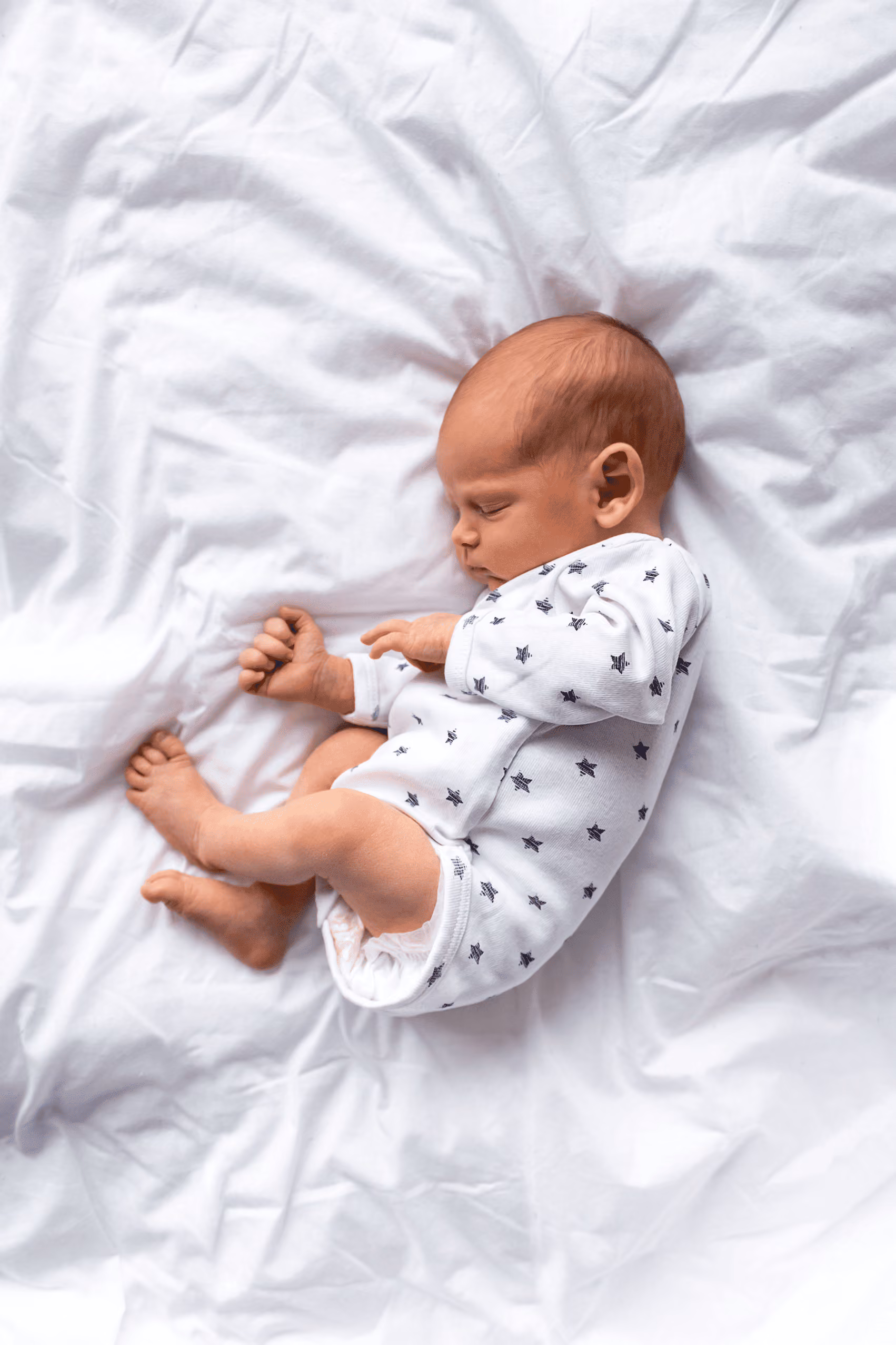 Mother resting with her newborn baby at home