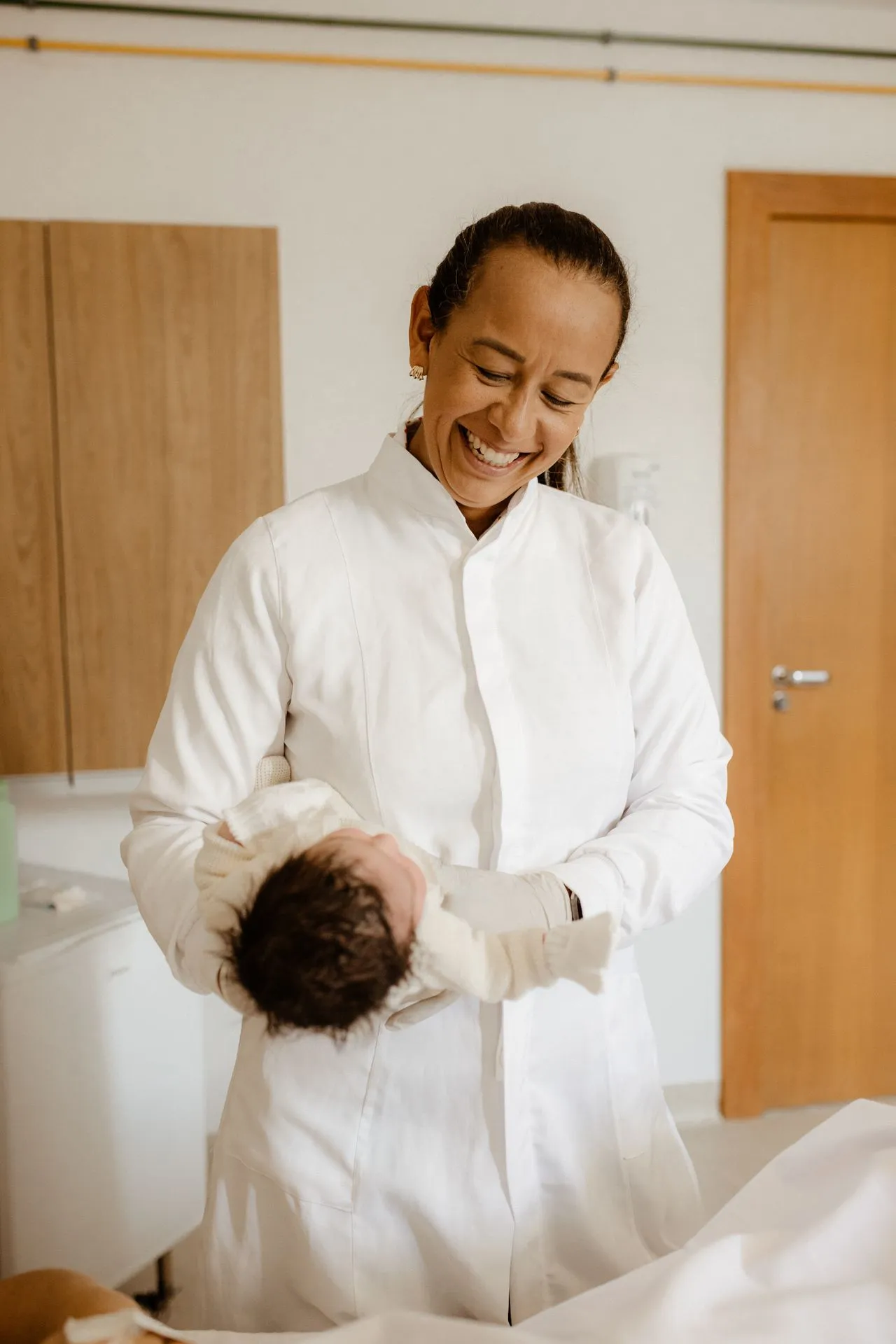 Healthcare professional holding a baby