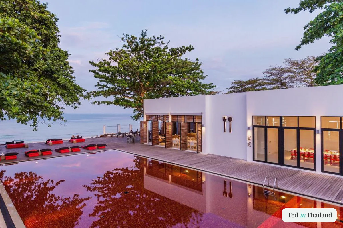 The signature red-tiled pool and beachfront restaurant at The Library on Chaweng Beach, Koh Samui, at dusk