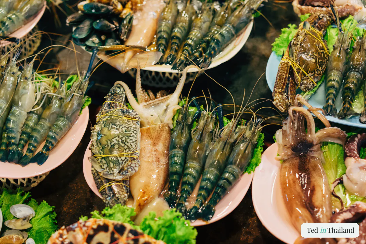 Fresh prawns, squid, crab and shellfish laid out at a seafood stall at the Thong Krut fishing village on Koh Samui's south coast