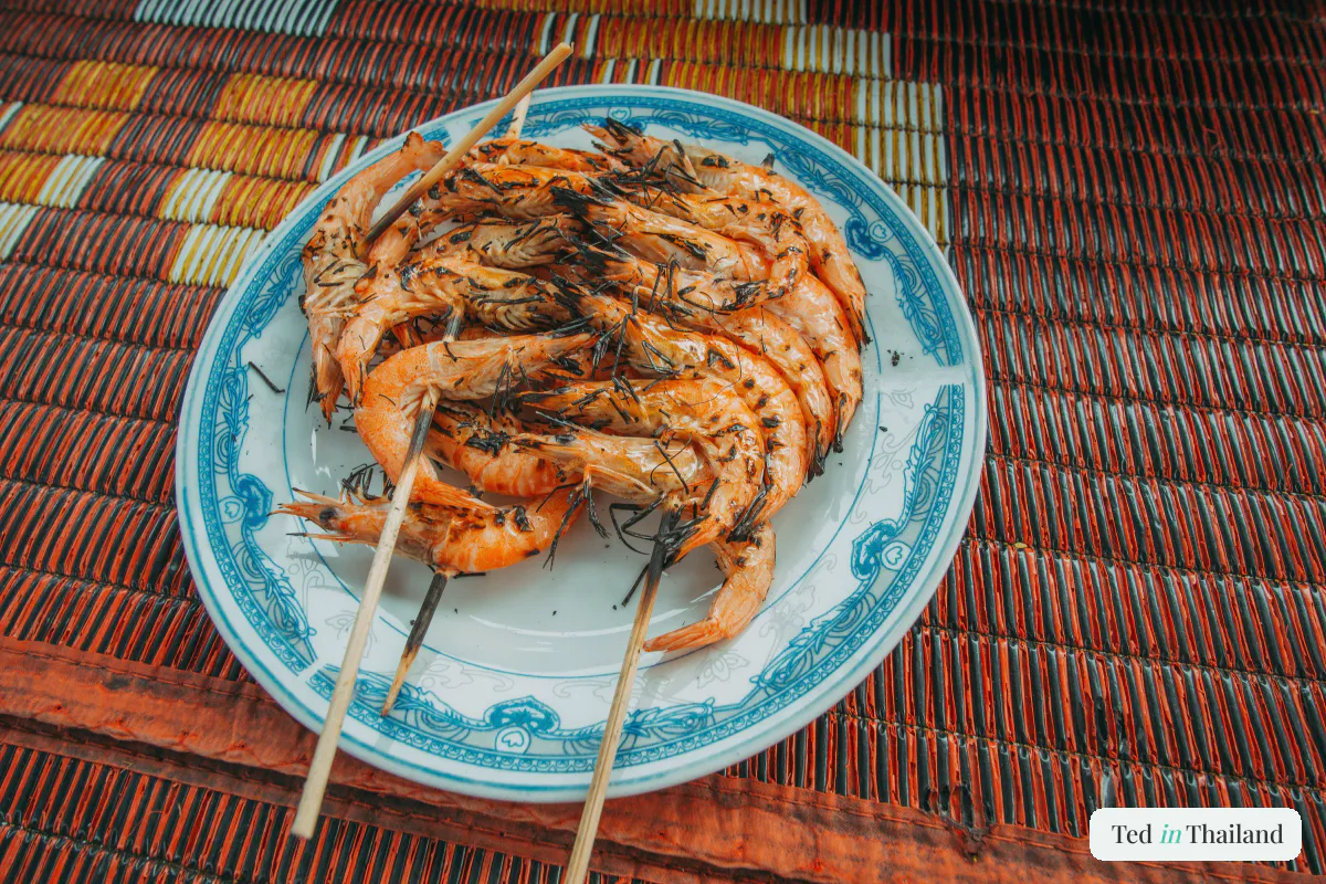 A plate of charcoal-grilled prawns on skewers, fresh seafood served at markets across Koh Samui