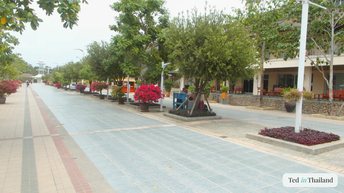 The open-air garden walkway through Koh Samui Airport (USM), lined with bougainvillea and tropical trees