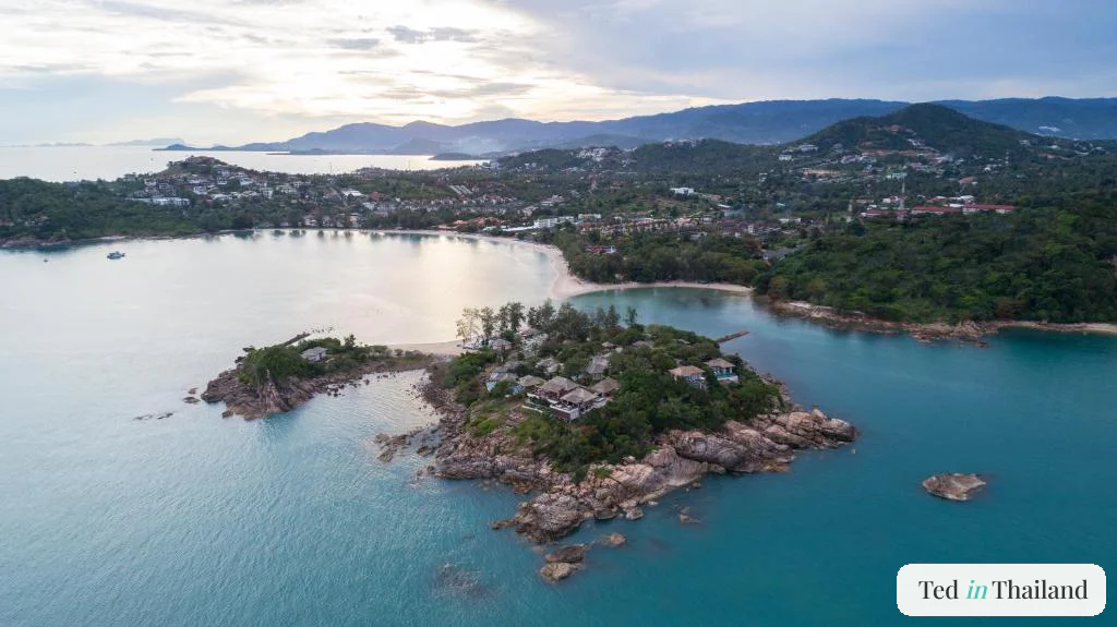 Aerial view of Cape Fahn Hotel's private island off Choeng Mon, villas on a rocky outcrop linked by a sandbar