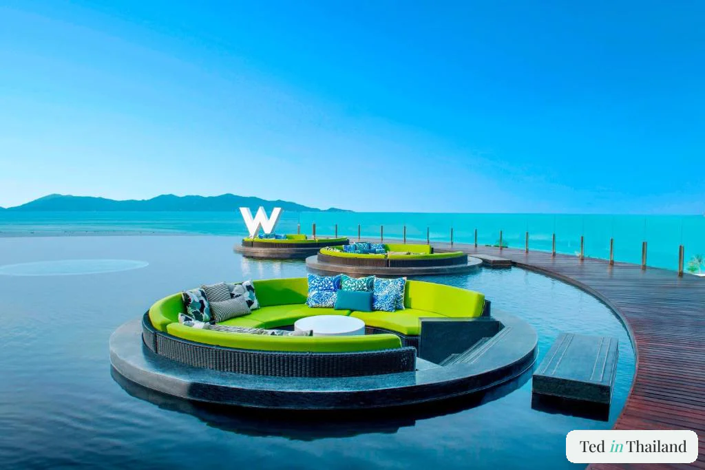 Lime-green circular lounge pods of WooBar set in the infinity pool at W Koh Samui on the Maenam coast