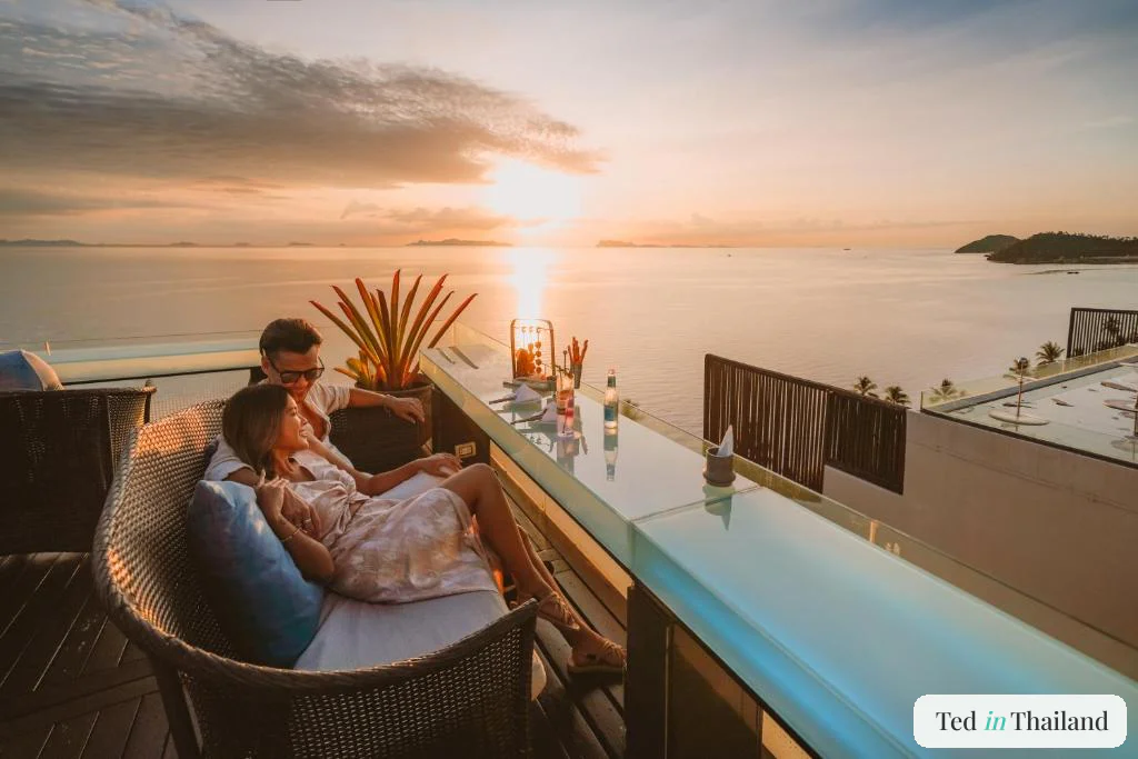 A couple watching the sun drop into the Gulf of Thailand from a west-facing terrace at InterContinental Koh Samui