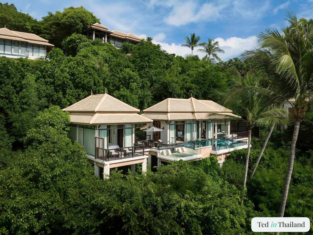 Two thatched-roof pool villas on stilts above the jungle hillside, each with a private infinity pool, at Banyan Tree Samui