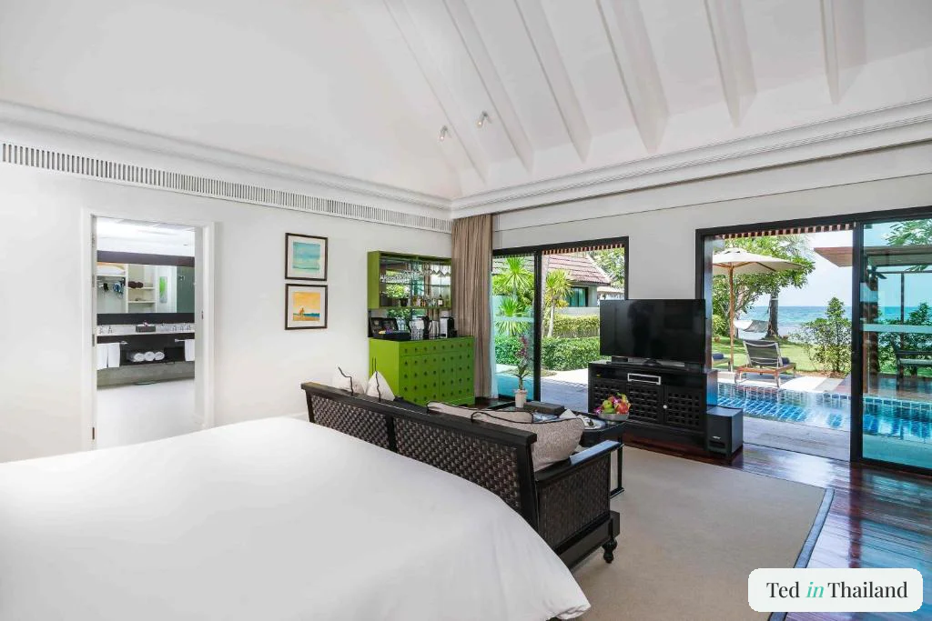 Beachfront villa bedroom at InterContinental Koh Samui opening onto a private pool and the west coast sea