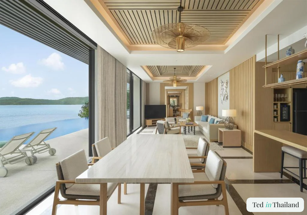 Open-plan living and dining room of a multi-bedroom villa at Conrad Koh Samui opening to the pool terrace