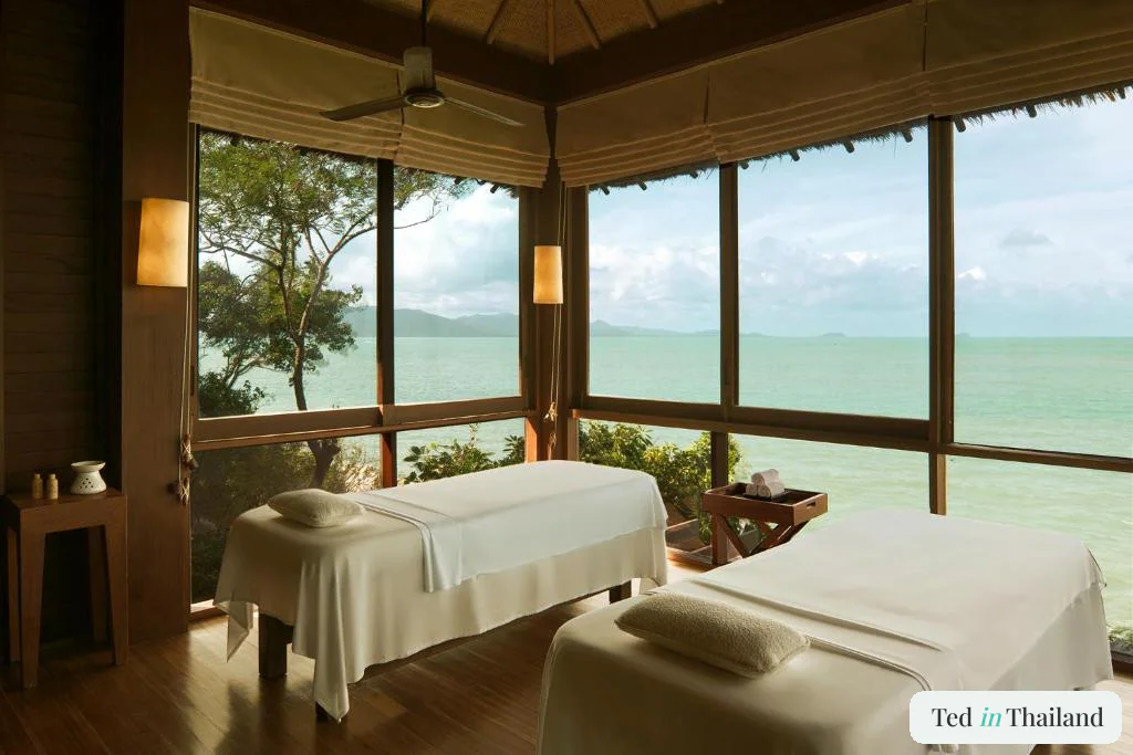 Twin treatment room at the Six Senses Samui spa with windows on three sides over the sea