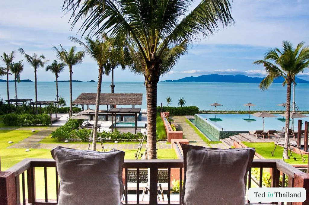 Balcony view over the infinity pool and palm-lined Bophut beachfront toward Koh Phangan at Hansar Samui