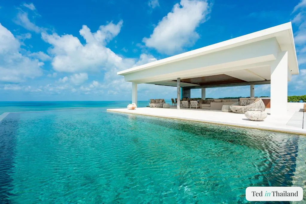 White open-sided pavilion beside the long infinity pool of a Samujana luxury villa on Koh Samui