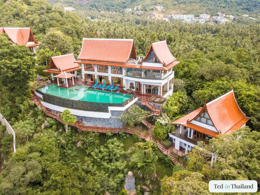 Aerial view of Villa Riva's orange-tiled Thai pavilions and 32-meter pool on the Laem Noi headland, Koh Samui