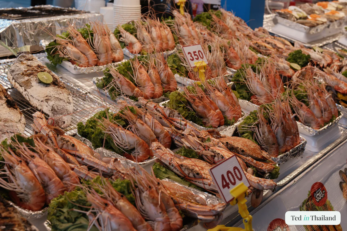 Giant prawns, crab and whole fish on ice with baht price tags, ready to grill at a Koh Samui seafood stall