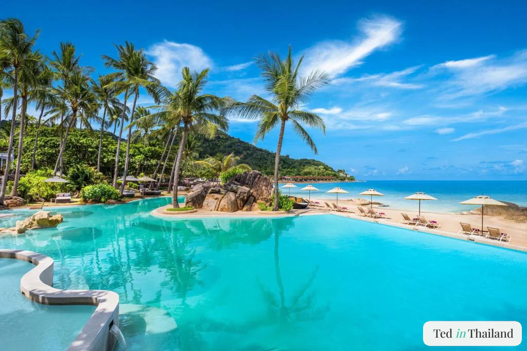 Tiered lagoon pool built around granite boulders and palms above the beach at Sheraton Samui Resort in Chaweng Noi