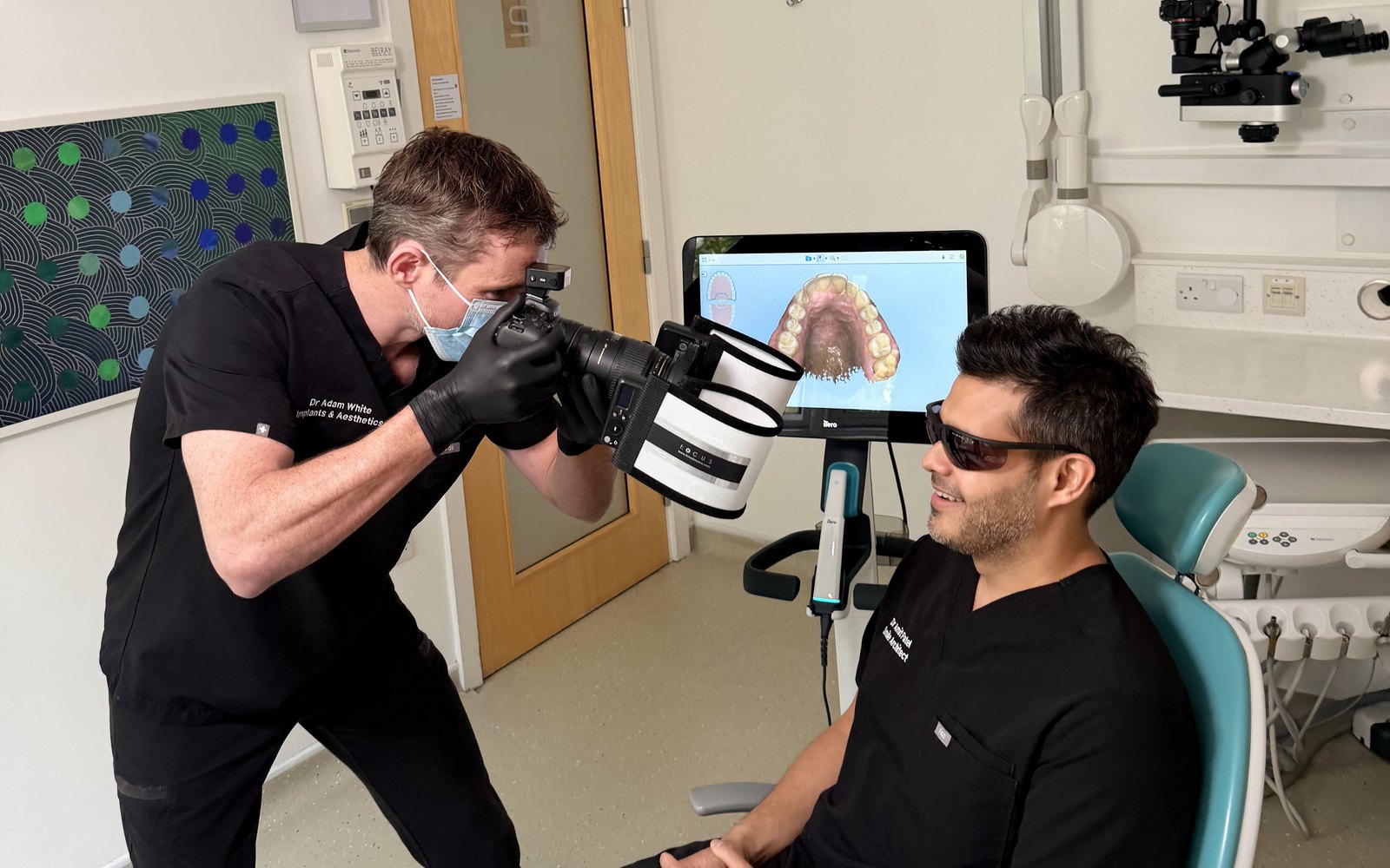A Bellevue Dental clinician taking clinical photographs in the surgery