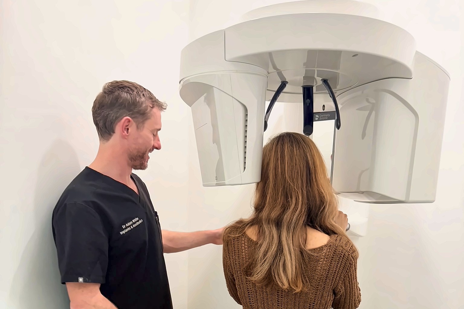 Dr Adam White with the 3D CBCT scanner at Bellevue Dental
