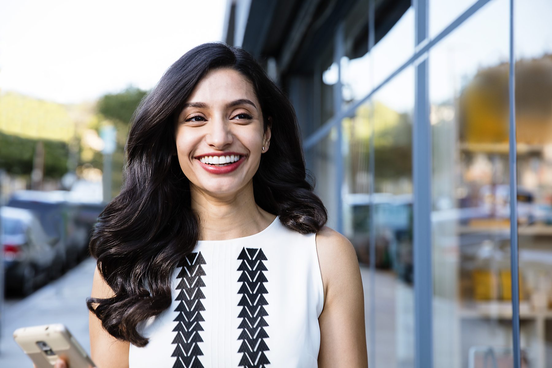 A smiling adult wearing Invisalign® clear aligners in everyday life