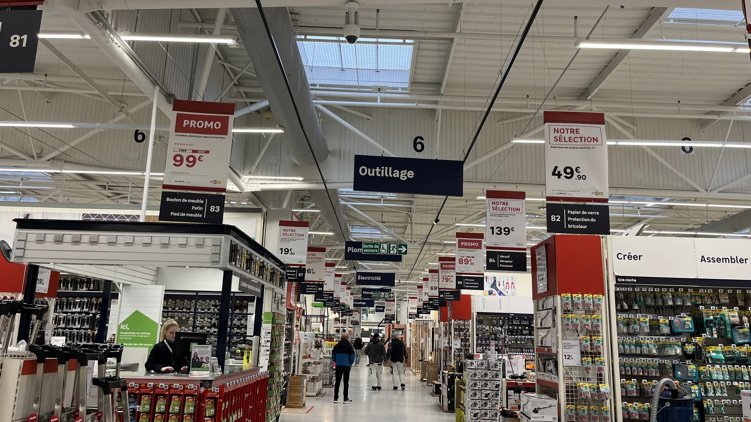 Allée d'un magasin de bricolage avec des affiches prix