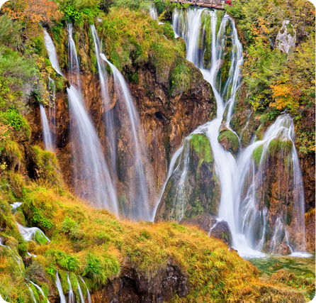 Plitvice Lakes Waterfalls with turquoise lakes and cascading falls surrounded by forest