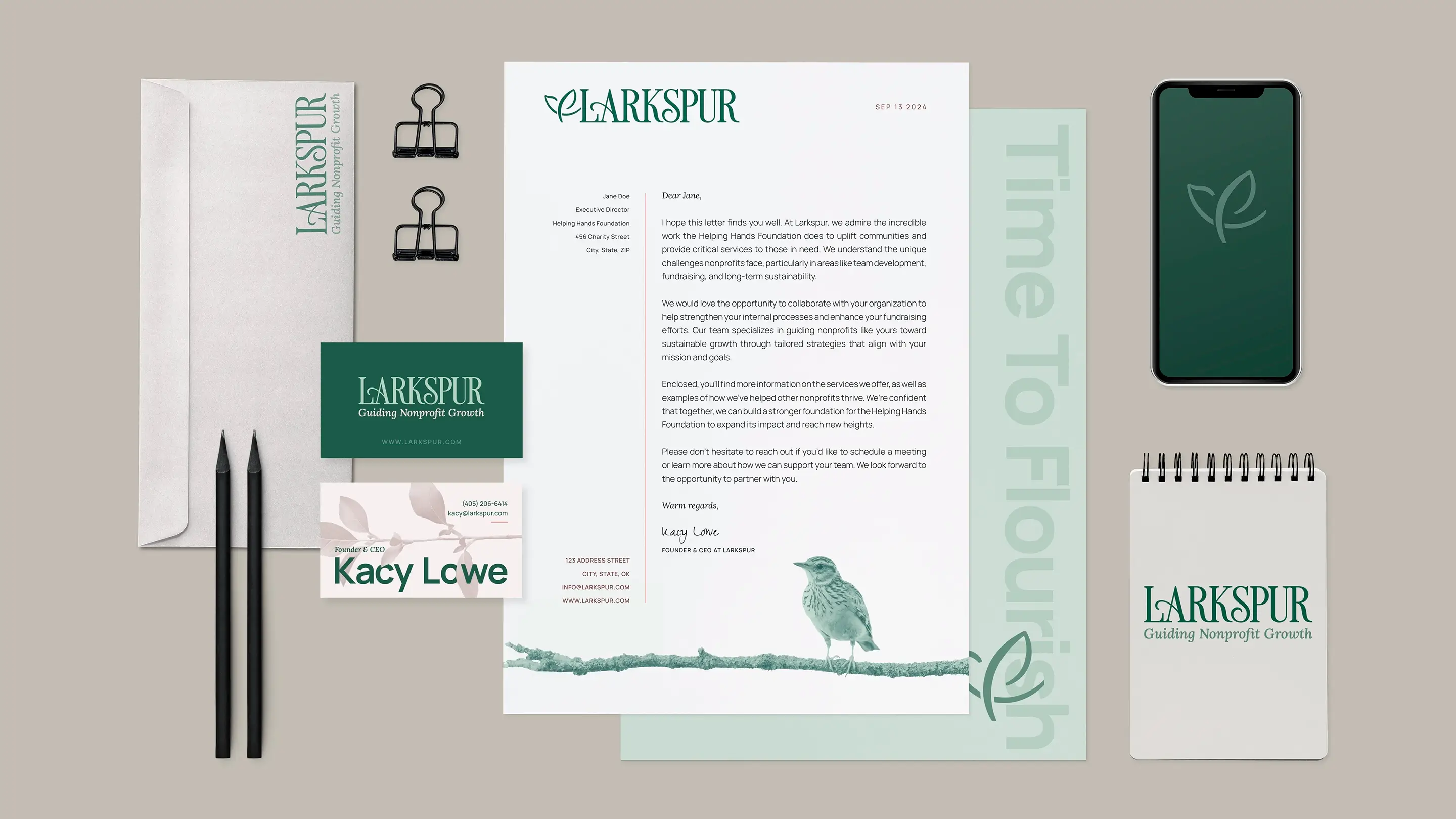Business paper suite for Larkspur - letterhead, business cards, and a notebook. Each item shows the brand in a new way, depicting birds, flowers and the logo. The brand is emerald green with a lot of negative space so it feels airy and peaceful.