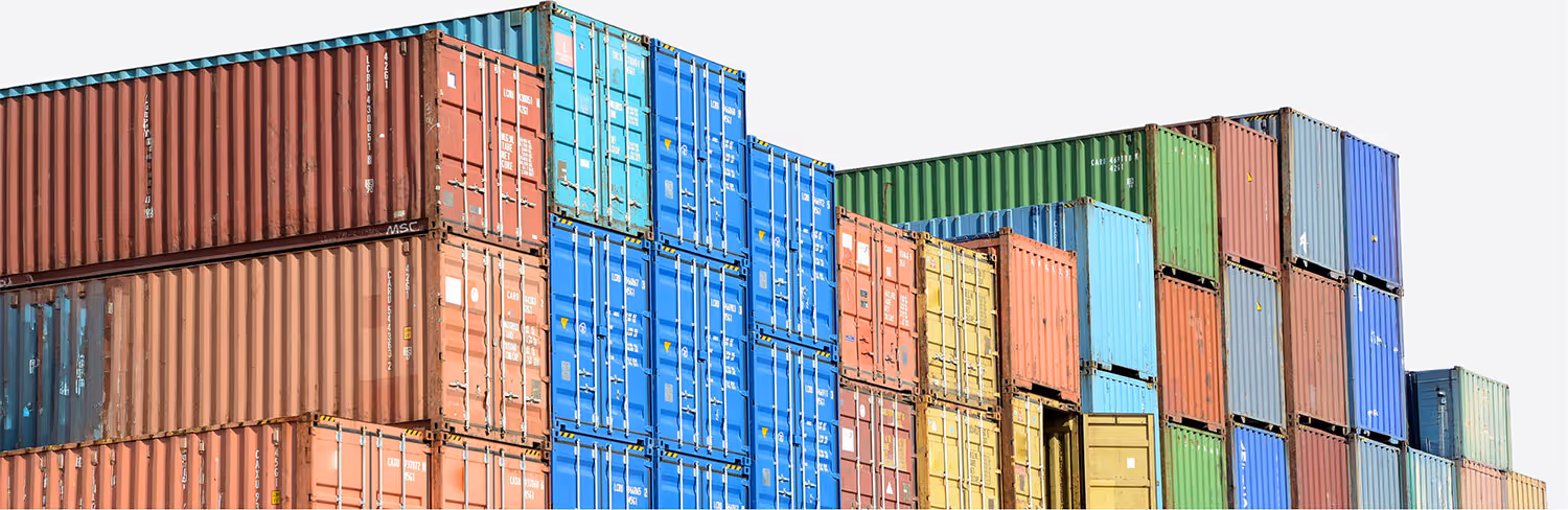 Stacked colorful shipping containers in various colors including red, blue, green, and yellow.