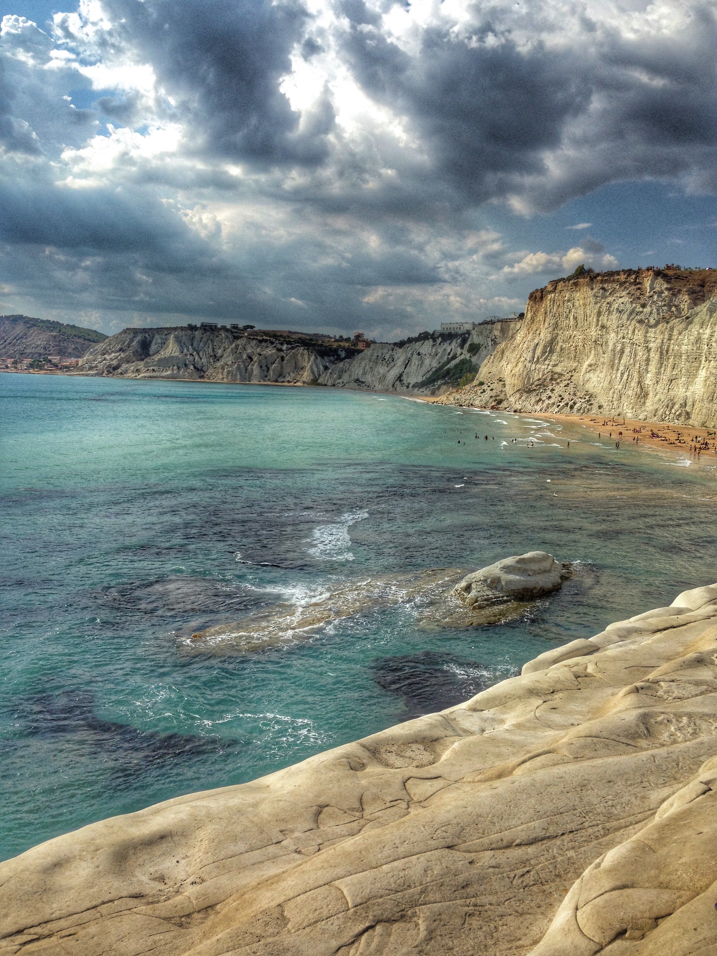 Crystal clear shades of emerald and turquoise water along the coast, Sicily, Italy.