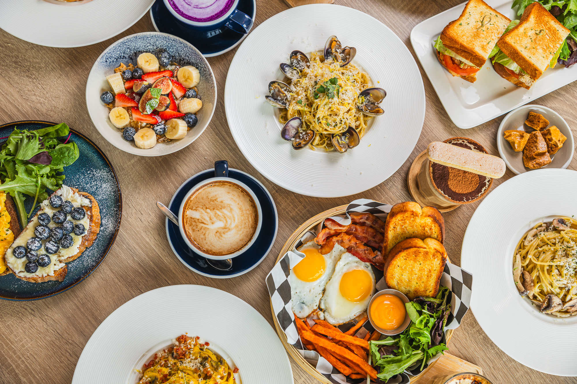 Group brunch order with pasta, pizza, drinks, and desserts at Karkumi Cafe in Scarborough.