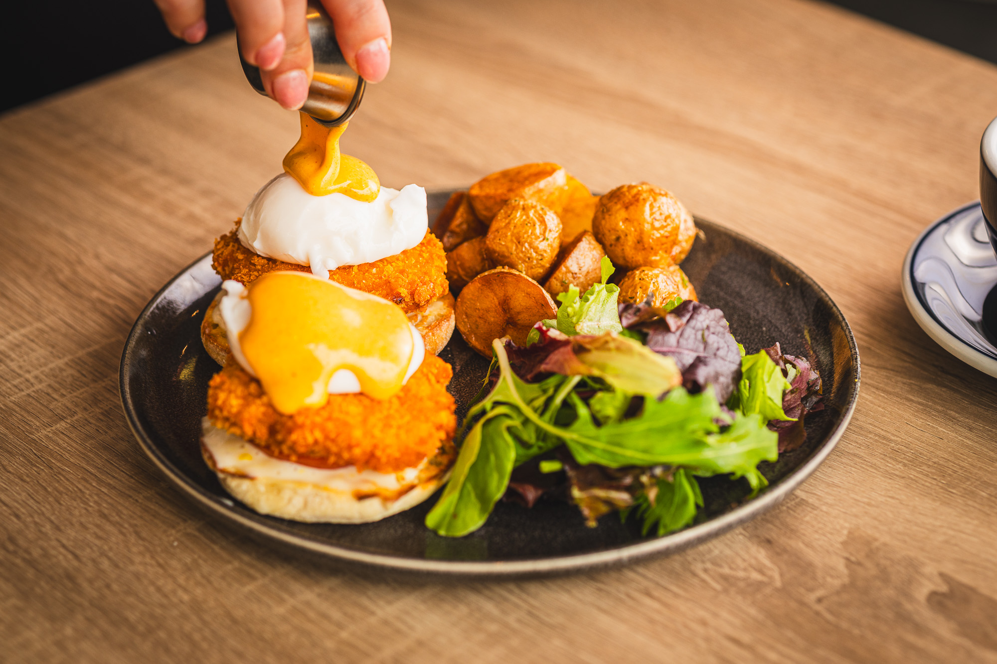 Eggs benedict with poached eggs and hollandaise at Karkumi Cafe in Scarborough.