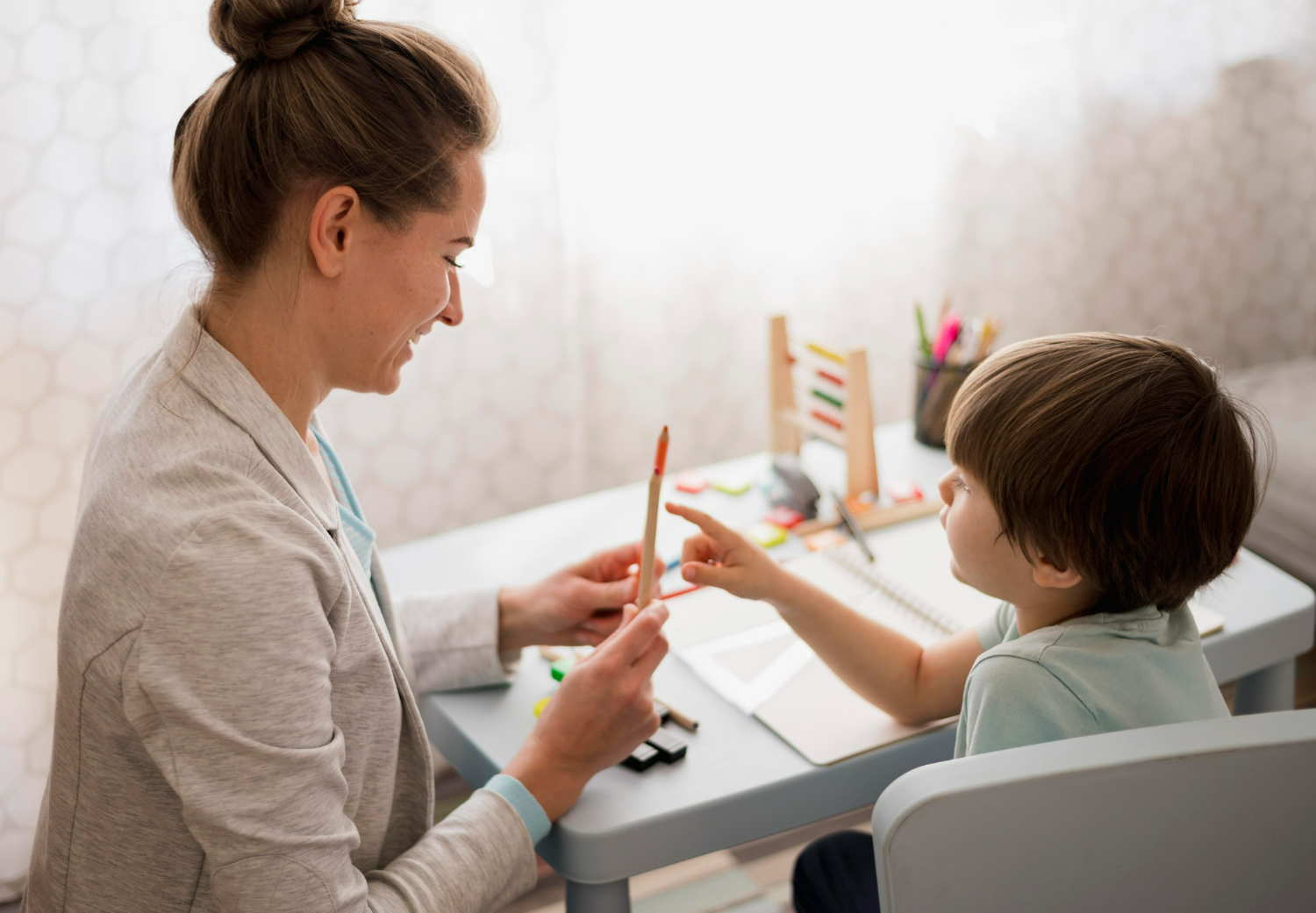 Child participating in pediatric speech, occupational, and physical therapy session with therapist at rehabilitation clinic in Texas