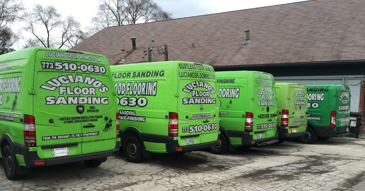 Five bright green vans parked with Luciano's Floor Sanding and contact info on their backs.