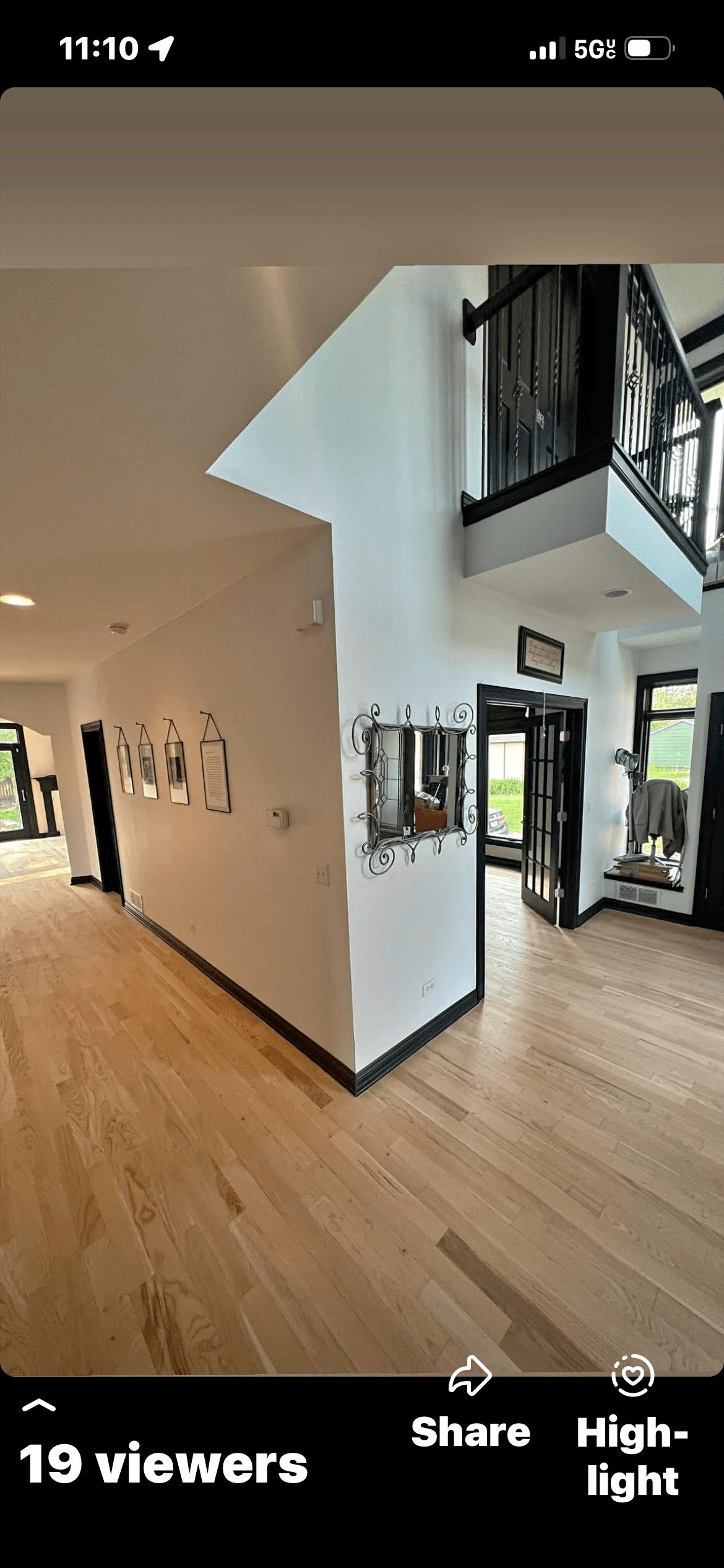 Shiny finished hardwood floor in a kitchen with wooden cabinets and a center island.