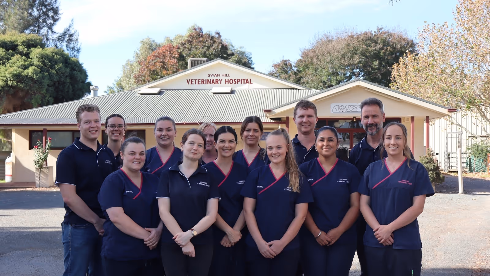 Group of veterinary staff standing in front of Swan Hill Veterinary Hospital building.