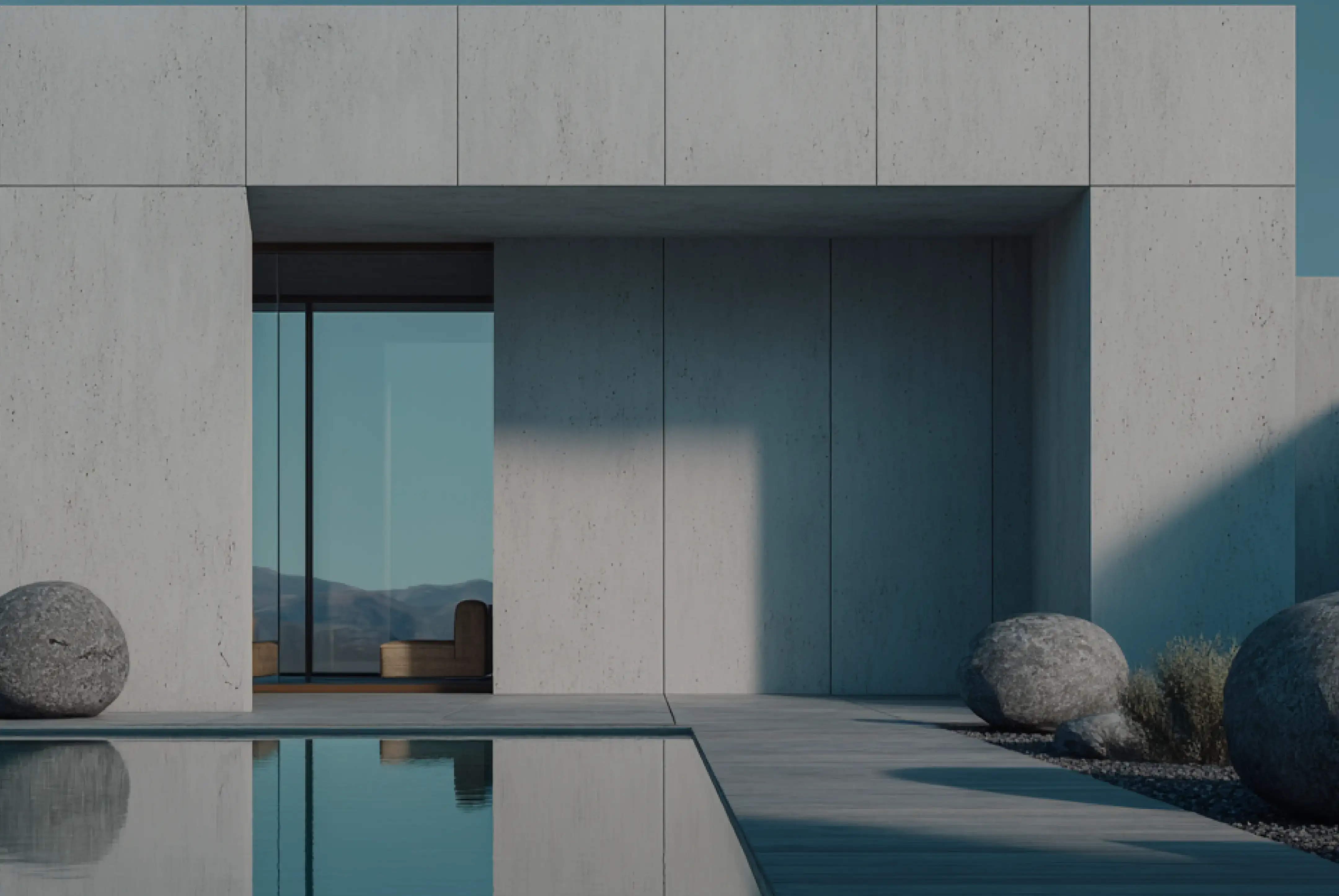 Modern concrete building with a pool, large rocks, and a sofa visible through a glass door.
