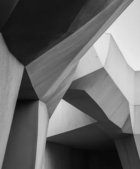 Abstract black and white architectural structure with angular concrete shapes and shadows.