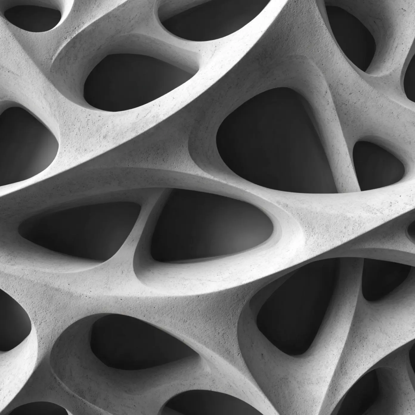 Close-up of an abstract, smooth, white sculptural surface with rounded, organic cutouts.