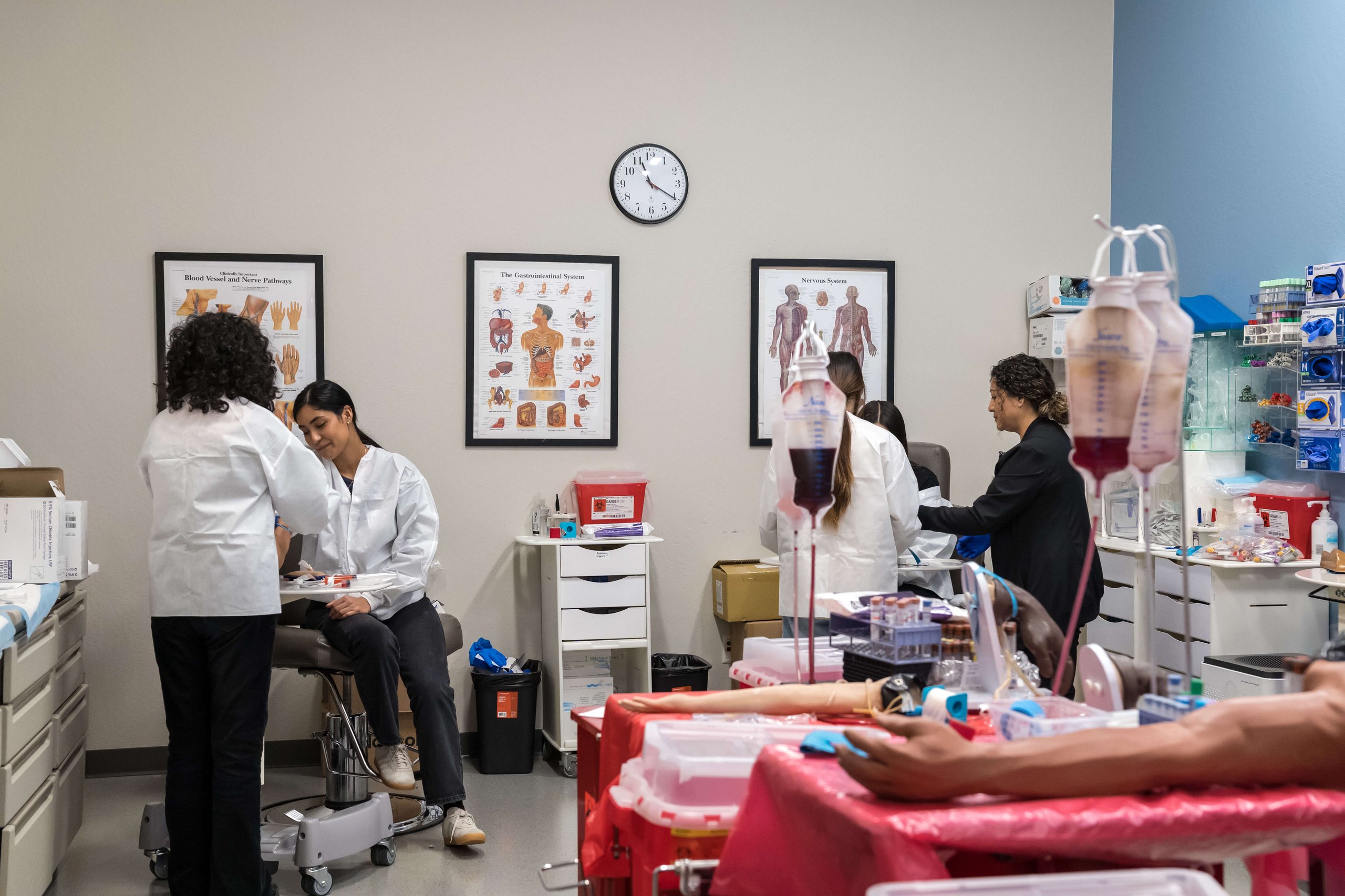 Students participating in a healthcare training activity in a clinical classroom.
