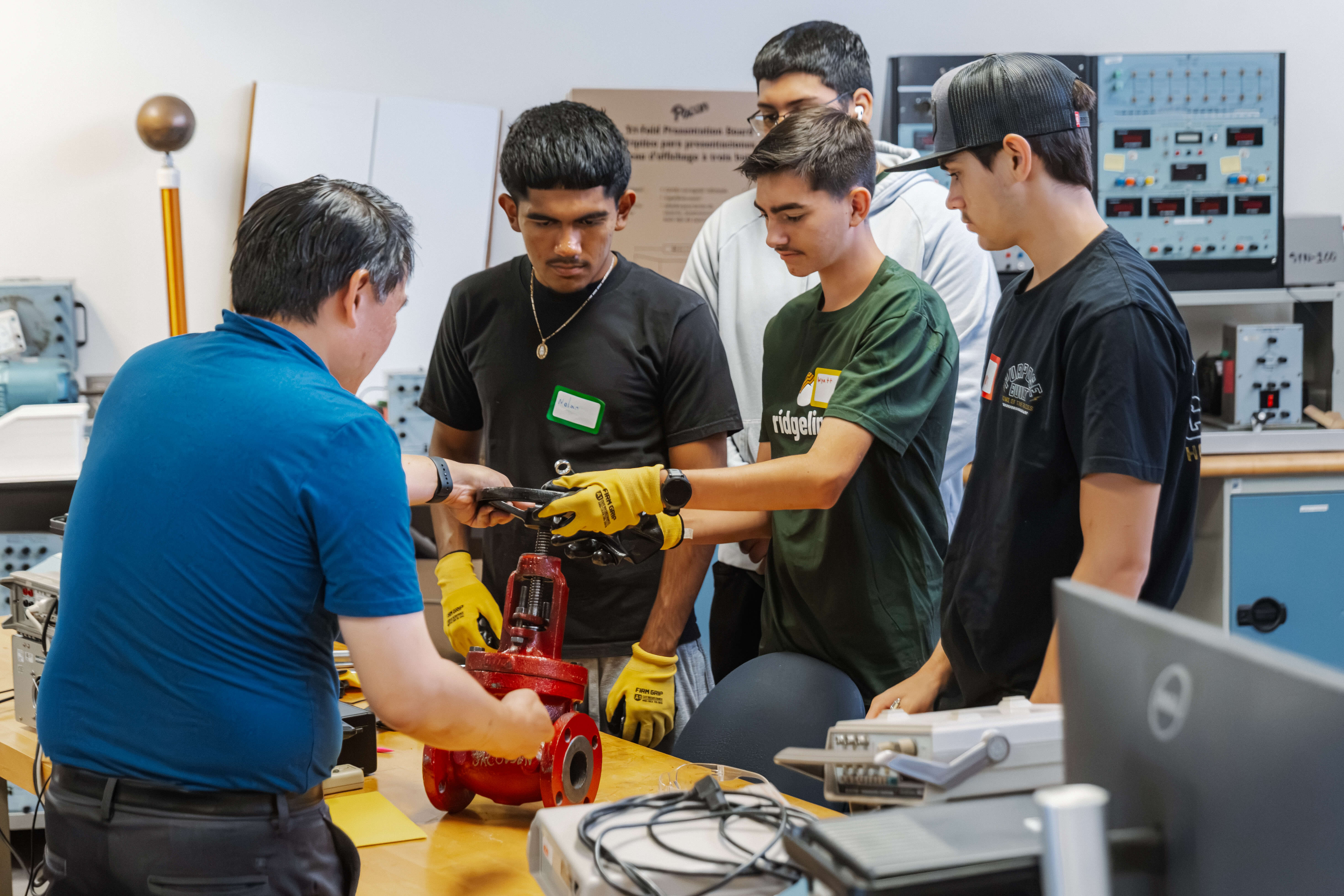 Students wearing protective medical gowns during a hands-on healthcare training activity.