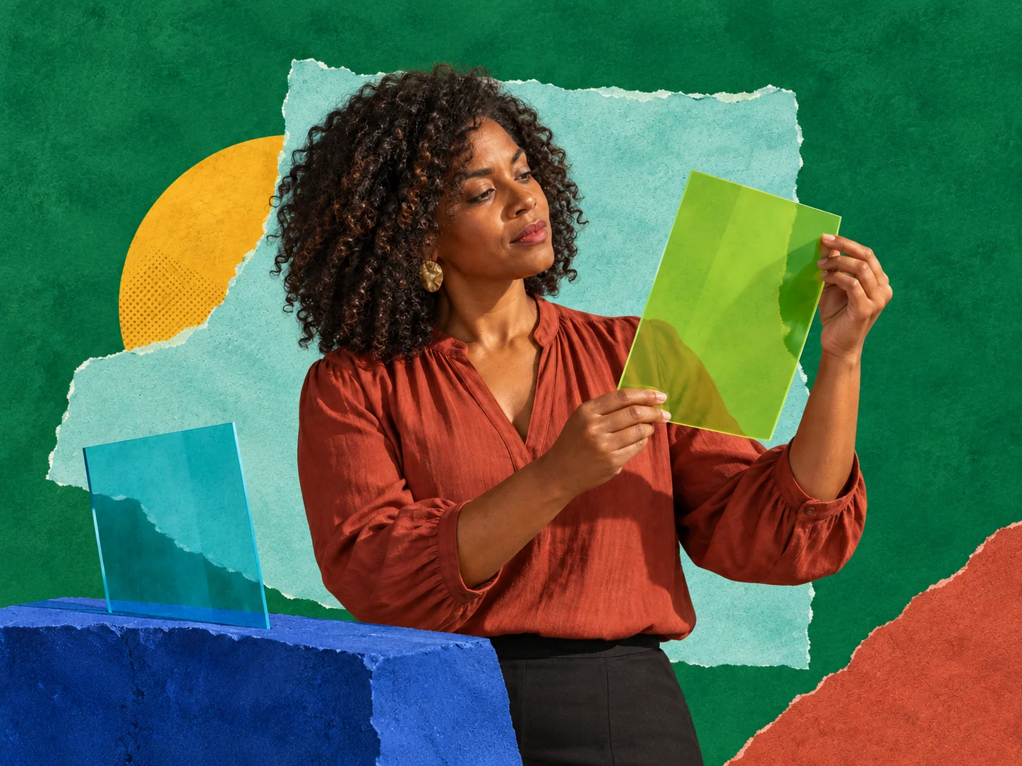 Woman in terracotta blouse examines a lime-green sheet against layered colorful paper.