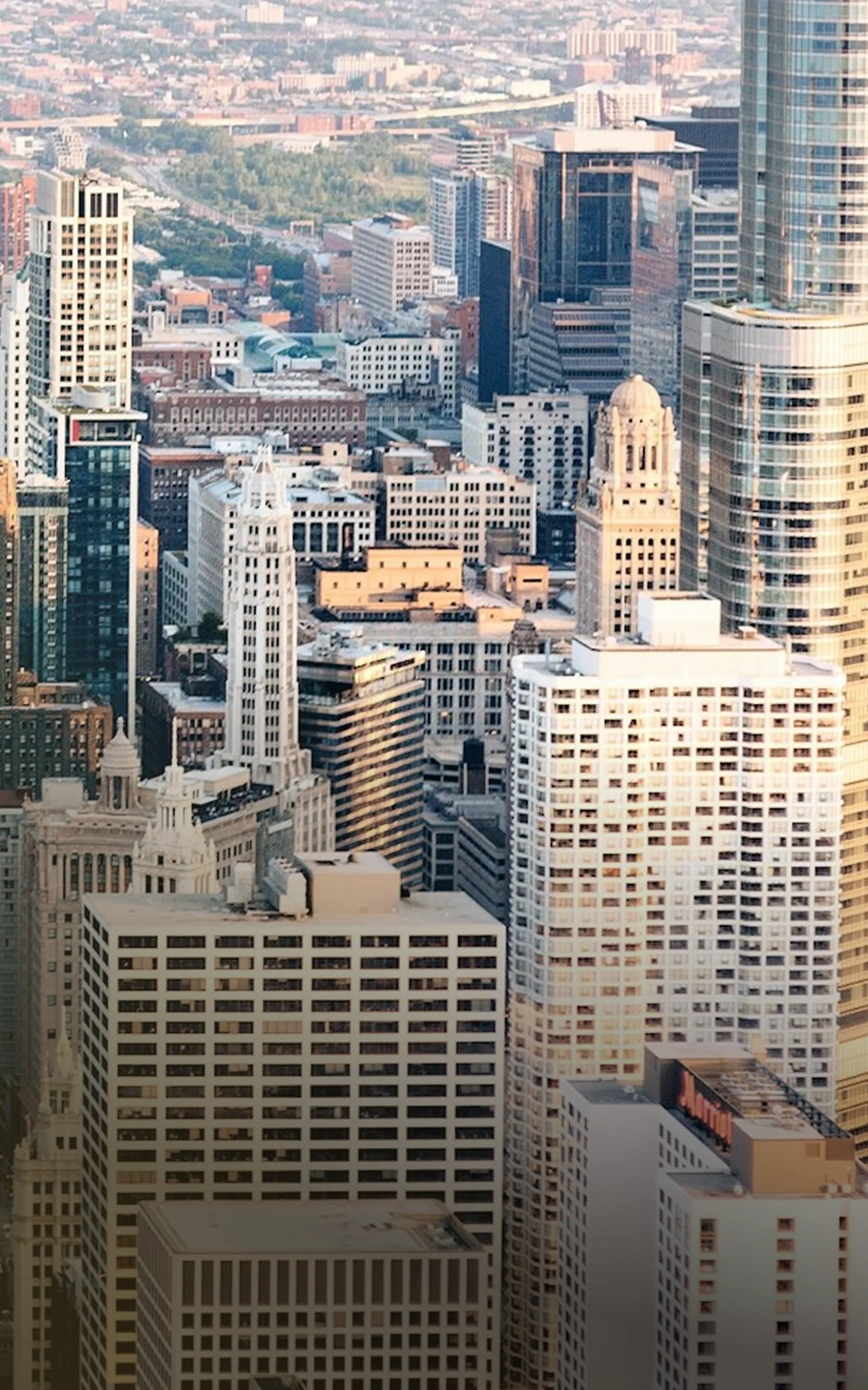 Dense cluster of various high-rise buildings in a cityscape during daylight.