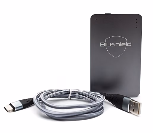 Blushield Ultimate portable device with a coiled gray USB-C to USB-A smart charger cable.