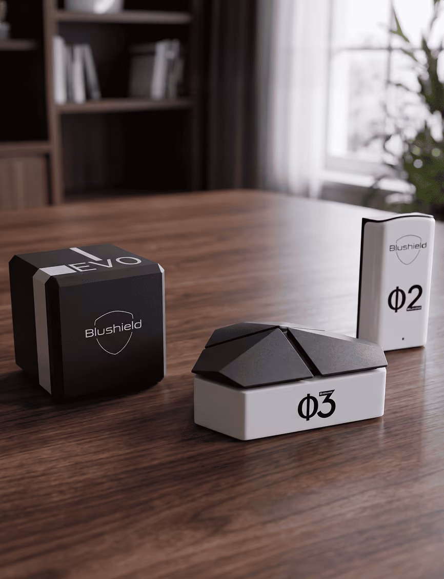 Blushield Phi devices displayed on a wooden floor in a room