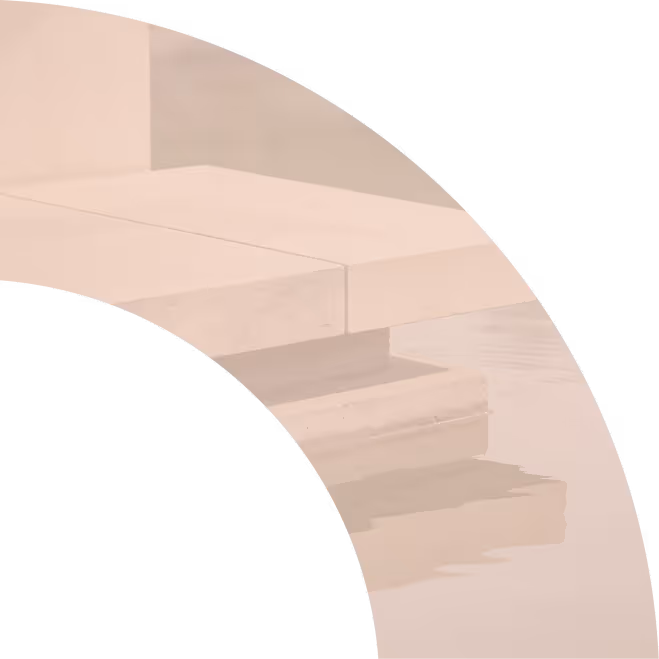 Close-up of the corner of a light stone or concrete platform reflecting on calm water.