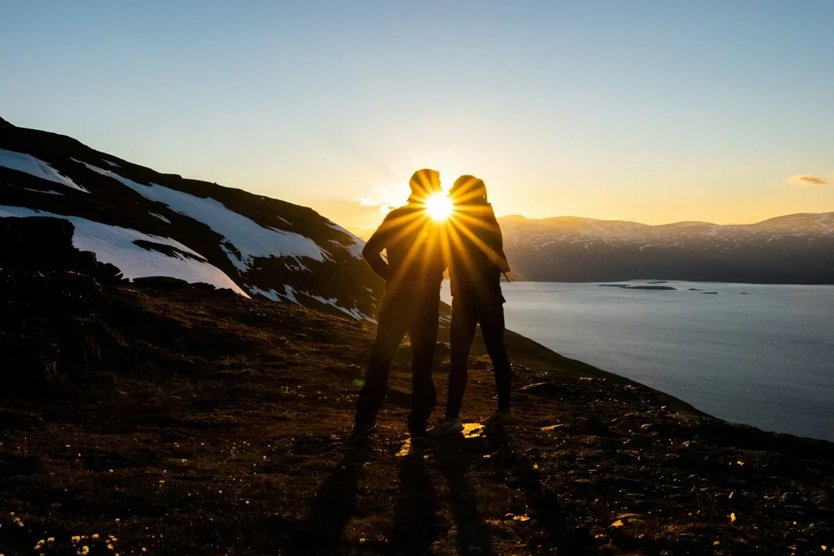 Couple hiking together at sunset