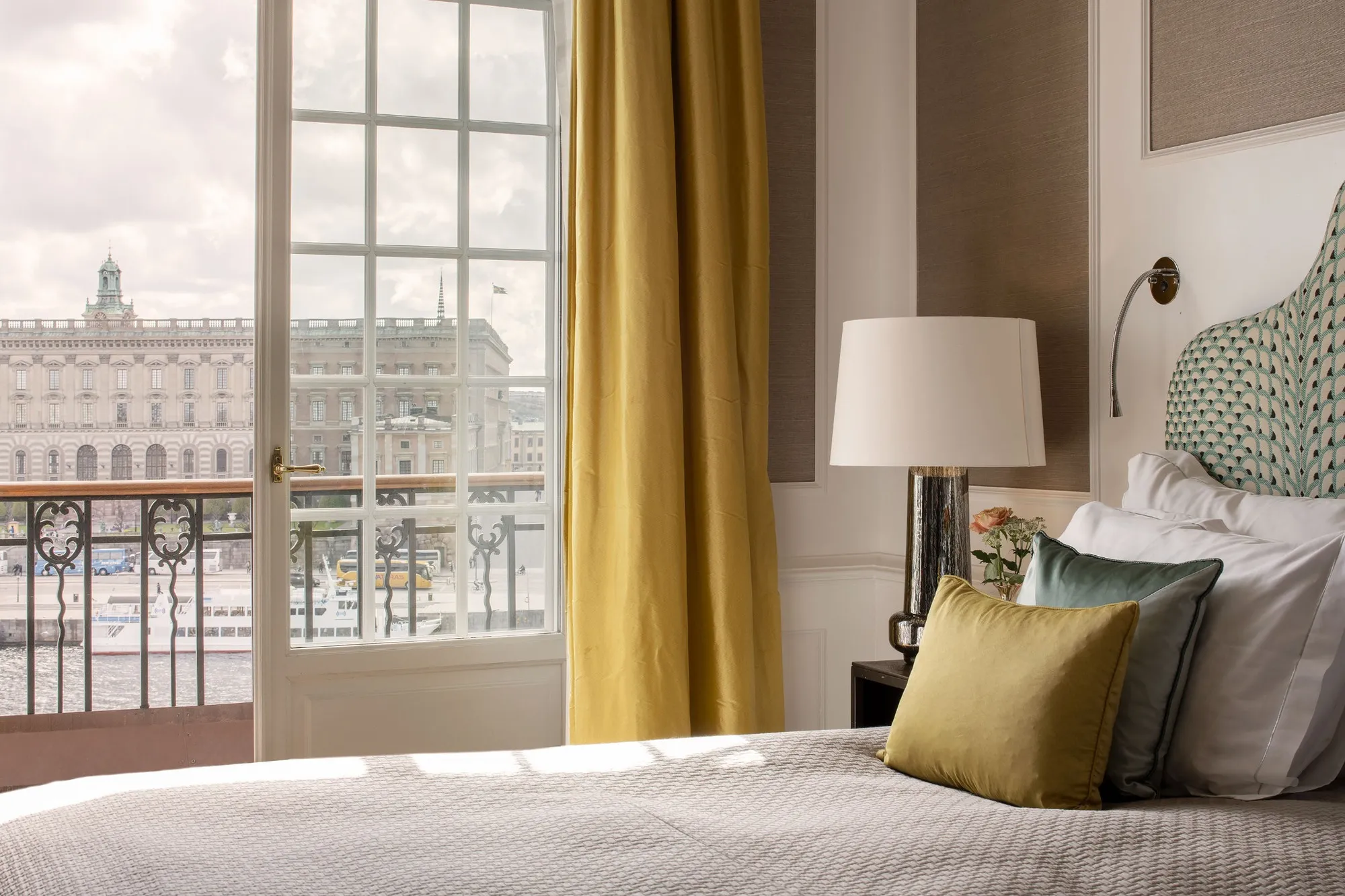 Elegant hotel bedroom with large windows and city views
